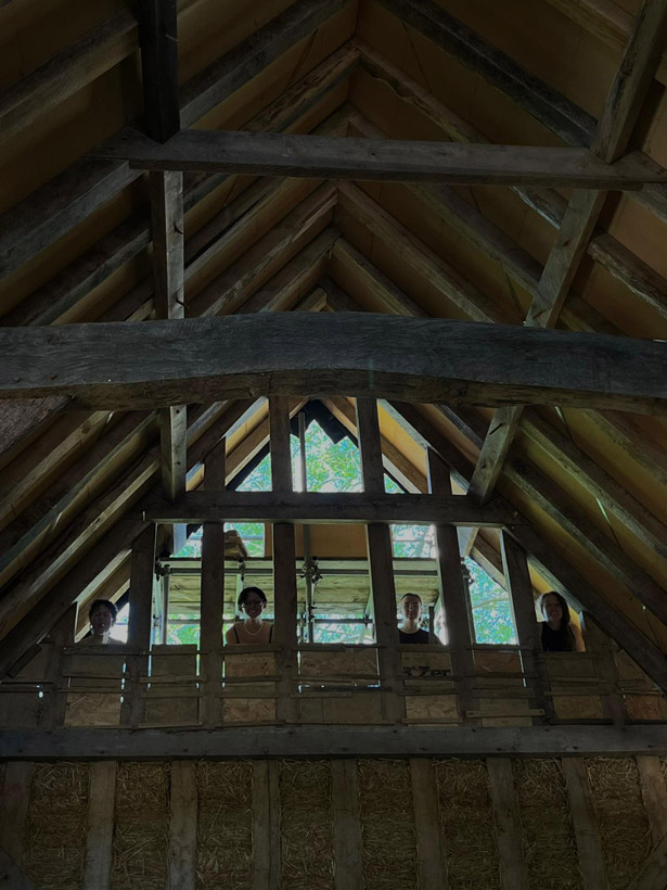 Volunteers packing natural insulation in north gable